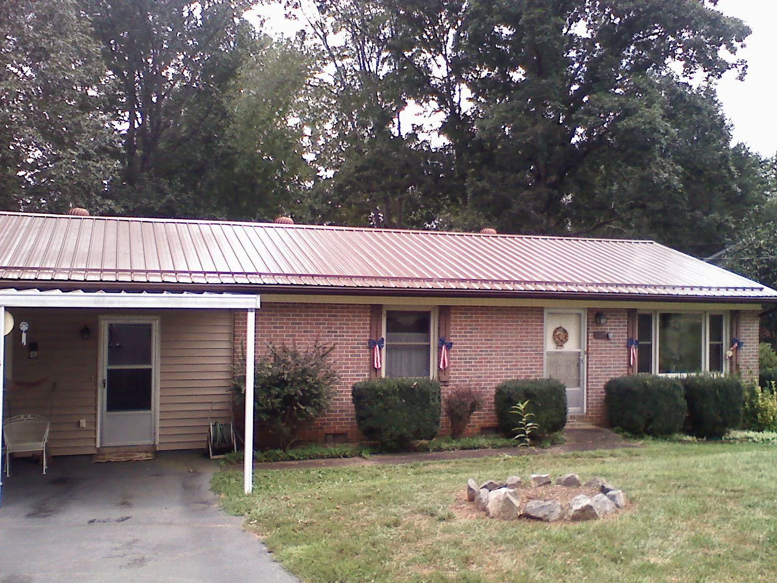 Bronze metal roof and carport on a brick ranch home — Roof Repair work by our crew in Paskenta